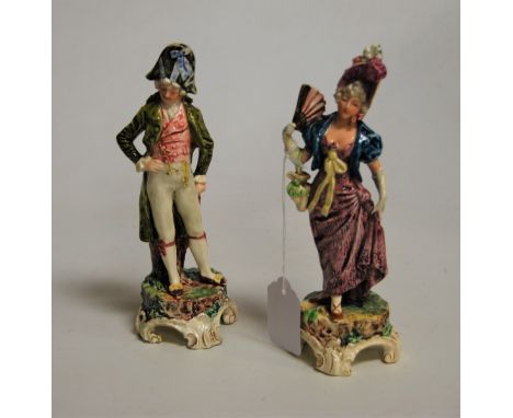 A pair of early 20th century Royal Dux porcelain figures, the lady in standing pose with purple dress and fan in hand, the ge