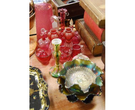 A collection of Victorian and later glassware, to include cranberry glass pitcher, amethyst carnival glass bowls etc