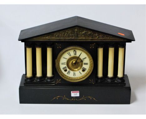A large late Victorian black slate cased mantel clock of architectural form, having enamelled chapter ring with Roman numeral