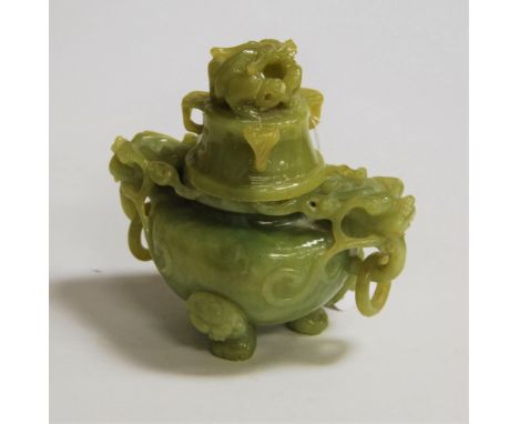 A reproduction Chinese carved jade style koro and cover, the cover surmounted by a dragon, having further dragon mask ring ha