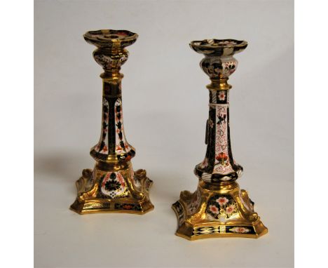 A matched pair of modern Royal Crown Derby bone china table candlesticks, in the Imari palette, one pattern No.2451 and the o