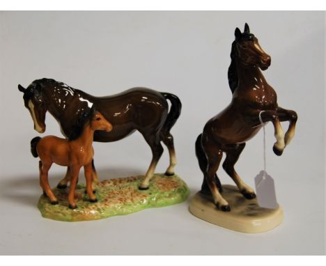 A Beswick model of a horse and foal, brown gloss finish, on naturalistic base, having circle Beswick mark verso; together wit