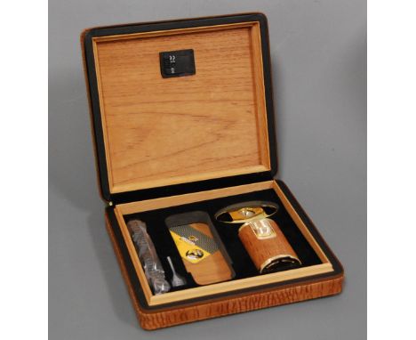 A faux crocodile skin clad humidor and contents to include Cohiba cigar lighter, cigar cutter etc
