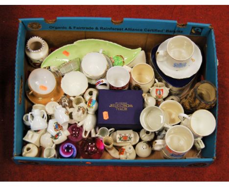 A collection of various ceramics to include Goss crested ware, Royal commemorative mugs, and a Poole pottery vase