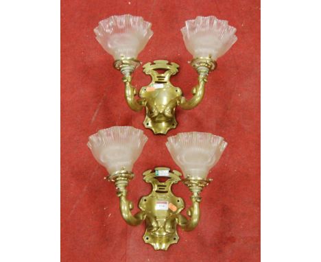 A pair of brass twin sconce wall light fittings, each with opalescent frilled glass shade
