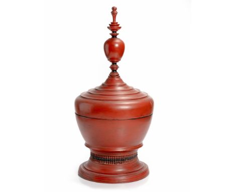 The tall removable finial rising above the stepped lid, the ovoid body raised on a splayed foot, age wear, lacquer loss69cm h