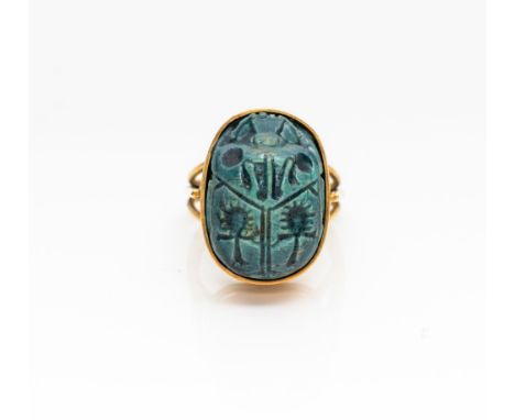 After the Ancient Egyptian, centred with a faience model of a scarab beetle, in 18ct gold, ring size K