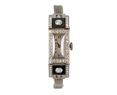 Manual, the rectangular silvered dial with black Arabic numerals and outer calibrated track, embellished with onyx slabs, one