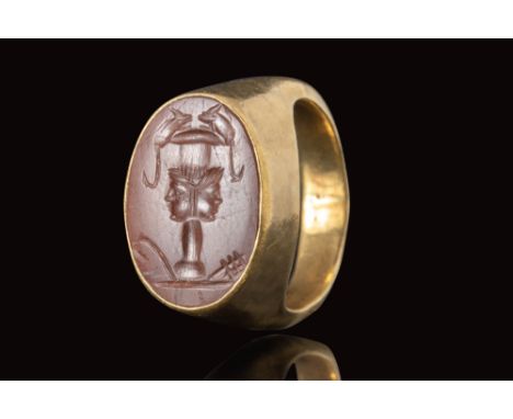 Ca. AD 50 - 150.
A gold ring with a D-section hoop and a high oval bezel, in which is secured a carnelian intaglio depicting 