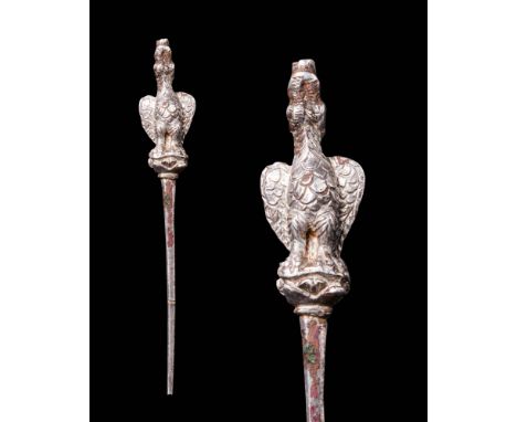 Ca. AD 100 - 300.
A charming cast silver-copper pin used to secure hair with a lengthy, slender shaft and a standing eagle fi