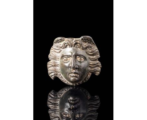 Ca. AD 100 - 300.
An exquisite ancient Roman phalera featuring the head of Medusa. The bronze face has silver inlaid eyes. Sh