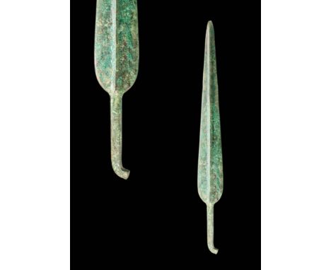 Ca. 1100 - 900 BC.
A moulded bronze dagger with a short, tapering blade, a prominent midrib and a guard. The hilt is characte