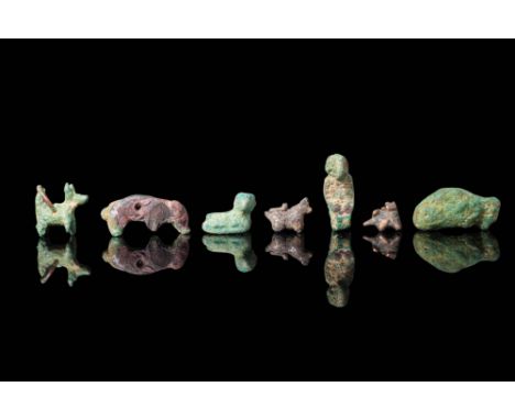 Ca. 3200 - 1500 BC.
A collection of seven Mesopotamian bronze amulets: two standing dogs, one standing pig, one recumbent bov