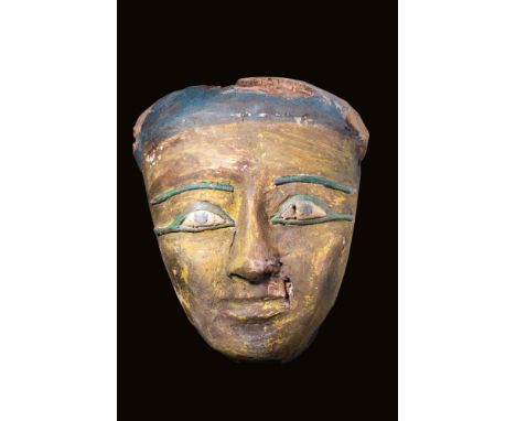 Late Period, Ca. 664 - 332 BC.
A large, finely carved wooden sarcophagus mask. It is carved from cedar and covered with gilt 