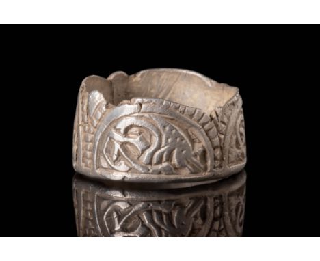 Ca. AD 800 - 900.
A Viking or Saxon silver mount made into a ring depicting beasts under arches adorned with a motif of squar