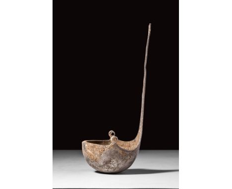 Ca. AD 100 - 300 .
A fine example of a cast-bronze ceremonial ladle with a shallow, hemispherical bowl and a lengthy handle t