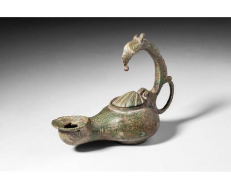 Ca. AD 100 - 300 .
A bronze oil lamp cast via the lost wax (cire perdue) method with a projecting ring base attached with a s