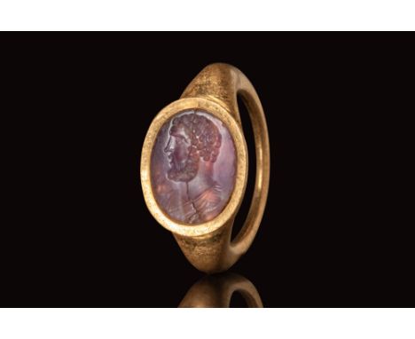 Ca. AD 100 - 150.
A gold ring with a D-section round hoop enlarged on the shoulders to form a bezel which secures an oval ame