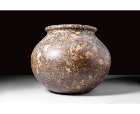 Ca. 3000 - 1793 BC.A granite vessel with a bulbous body that elegantly emerges from a circular base. The body terminates in a
