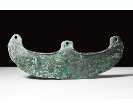 Ca. 2045 - 1794 BC.
A bronze, crescent-shaped axe head with three pierced holes for attachment to a handle. Cast using the lo