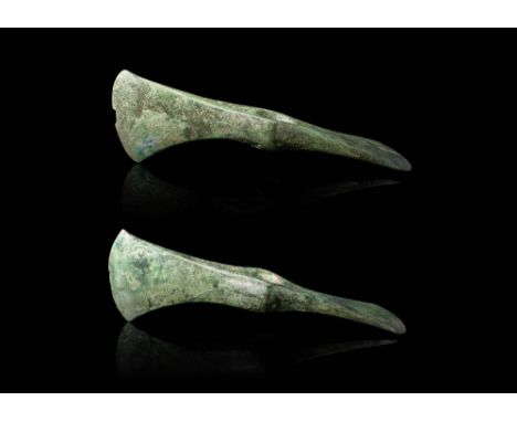 Ca. 1200 - 800 BC.
A pair of cast bronze adze heads with a cylindrical socketing shaft, a tapered spike on the back end, and 