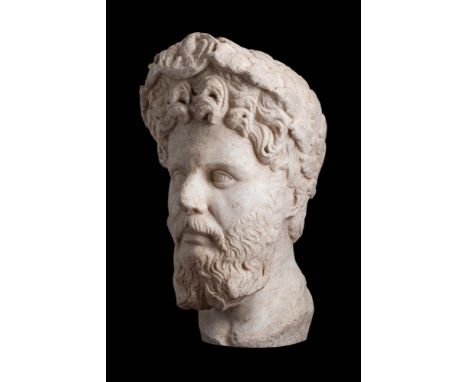 Ca. AD 193 - 211 .
A Roman over the life-sized head of Septiumius Severus depicted facing forward with the thick curling hair