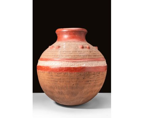 Ca. 19th Century.
A large red earthernware pottery jar, decorated with stamped patterns and knob handles on the globular body