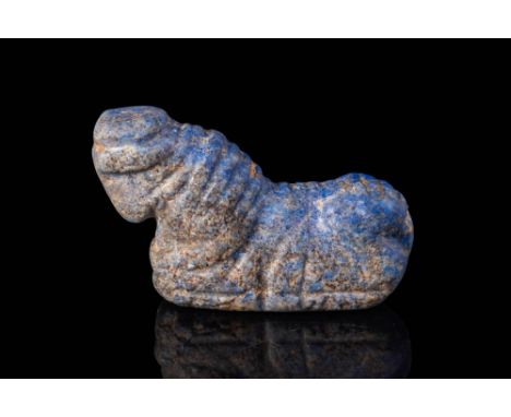 Ca. 2500 - 2000 BC.
A Mesopotamian Lapis Lazuli amulet in the form of a recumbent bovine resting on a flat base, pierced just