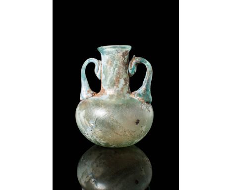 Ca. AD 300 - 500 .
A glass amphoriskos with an apple-shaped body, large neck, a short everted rim and two strap handles conne