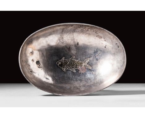 Ca. AD 400 - 500.
A decorated silver bowl in the shape of a boat. Longitudinally oval bowl of embossed silver with a short su