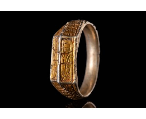 Ca. AD 1400.
A medieval British silver gilt iconographic ring with a round hoop divided by high mid-rib embellished with gilt