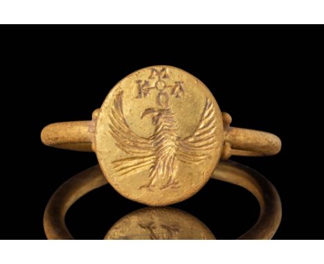 Ca. AD 500 - 700.
A gold seal ring with a simple tubular section and round hoop embellished on the shoulders with two gold pe