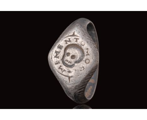 Ca. AD 1700.
A silver ring with a D-section round hoop enlarged on the shoulders to form a square bezel engraved with a skull