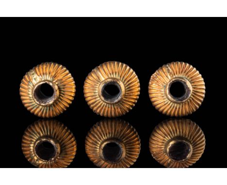 Ca. 300 - 100 BC.
Set of three gold ribbed beads pierced vertically, each with a globular body embellished with longitudinal 