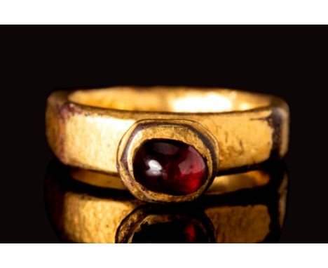 Ca. AD 400 - 600.
A Merovingian gilt ring connected to a high octagonal bezel set red garnet cabochon. For similar see: Byzan