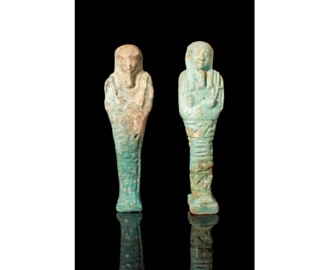 Late Period, Ca. 664 - 30 BC.
A pair of faience ushabtis covered in layers of reflective pale green-hued glaze. The figures s