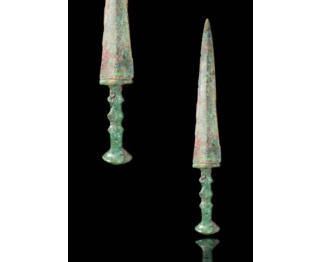 Ca. 1200 - 800 BC.
A bronze short sword cast via the lost wax (cire perdue) technique. The tubular handle is reinforced with 