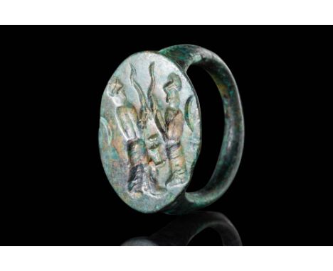 Ca. 400 - 300 BC.
A bronze ring with a round hoop in D-section, connected to a round bezel engraved with two man figures, pro