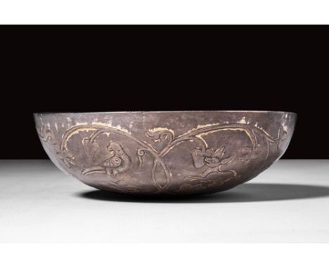 Ca. 300 - 100 BC.
A decorated silver bowl of round shape. The bowl of embossed silver with a short sub-vertical rim, embellis