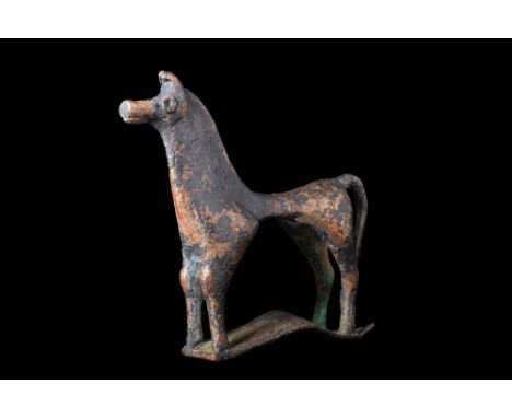 Ca. 800 - 700 BC.A fabulous cast-bronze horse presenting characteristically abstract geometric-era stylisation. The tubular a