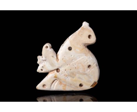 Ca. 3000 - 2500 BC.
A Mesopotamian mother of pearl amulet. A stalking bird of prey in shallow relief, decorated with drill-ho