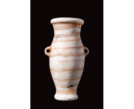 Late Period, Ca. 664 - 332 BC.
An alabaster alabastron with a piriform body connected to a short cylindrical neck and a folde