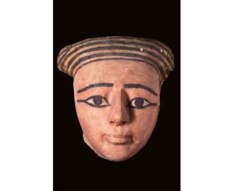 25th Dynasty, Ca. 750 - 650 BC.
A carved wooden sarcophagus mask in cedar, covered with gesso and gilt. Idealised facial feat