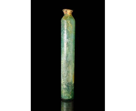 Ca. 100 BC - AD 100.
A glass jar with an elongated tubular body, a short funnel-shaped opening, and a flat base.
Size: 350mm 