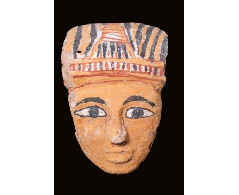 Late Period, Ca. 664 - 332 BC.
An intricately carved cedar wood sarcophagus mask coated in gesso and paint. The mask features