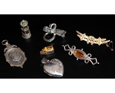 Small Mixed Lot Of Jewellery Comprising A 9ct Gold Bar Brooch (2.9g), Silver Locket, Silver Charm In The Form Of A Miners Lam