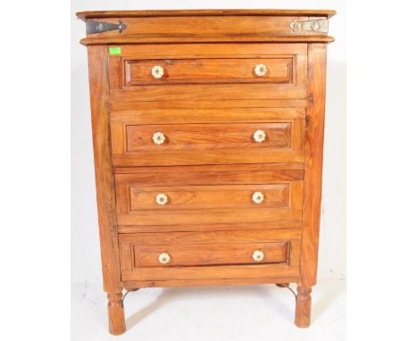 A contemporary hardwood chest of drawers. Raised on turned legs with a bank of four drawers having ceramic flower head handle