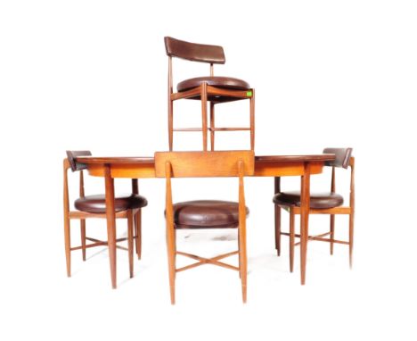 A retro vintage mid 20th century G-Plan teak wood extending dining table with four chairs. The table of oval form with taperi