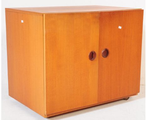 A retro vintage teak wood pedestal TV record media cabinet. The cabinet is of rectangular form, having dual doors to the fron