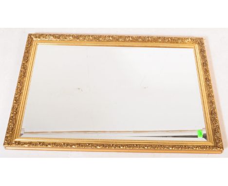 A large retro vintage mid 20th century guilt framed over mantle wall mirror. The frame being gilt resin cast frame and in rec
